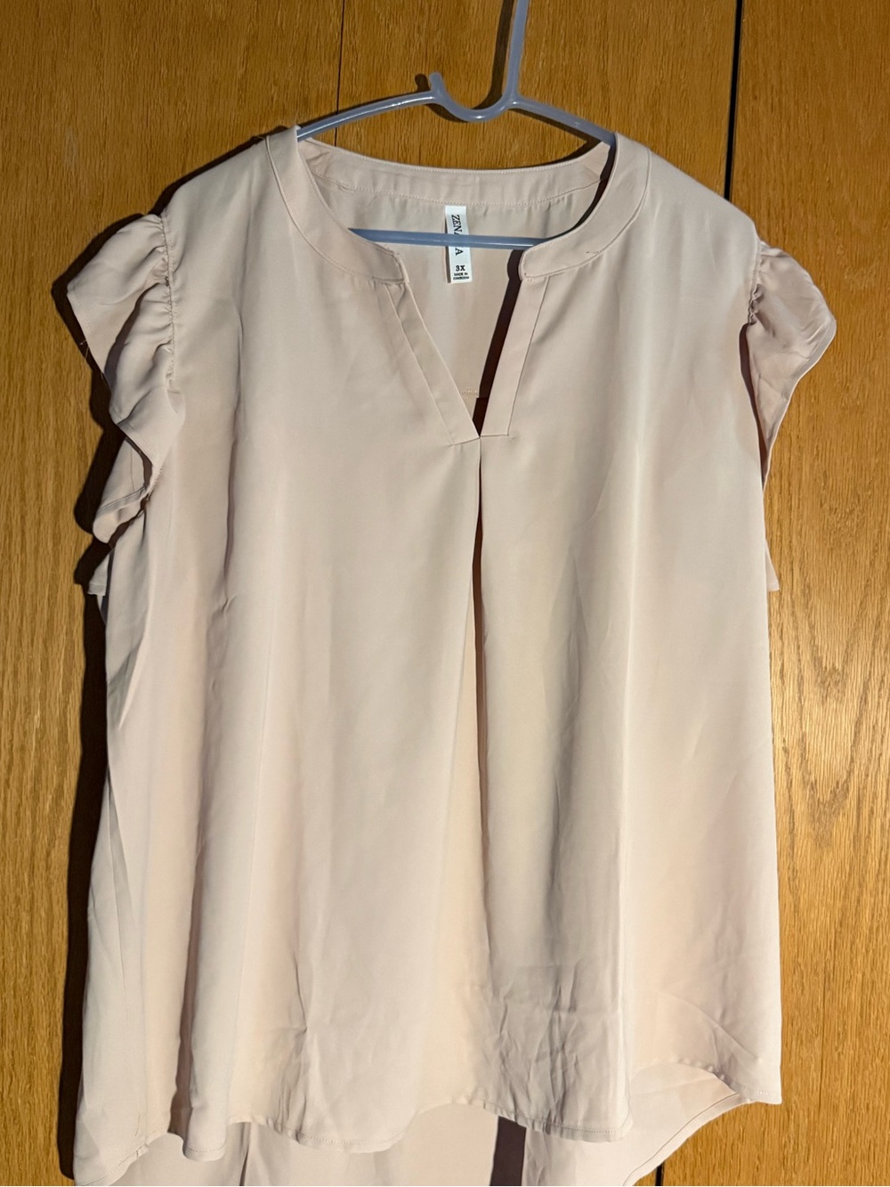 This Zenana blouse is a gorgeous blush color. Loose fit. Hangs